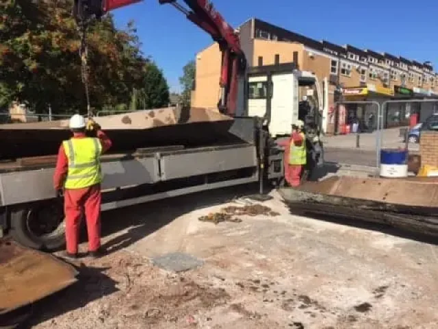 Loading the cut sections of tank for disposal.